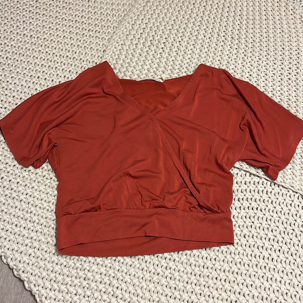 almost silky material, very cute and flattering, little bit of v-neck
